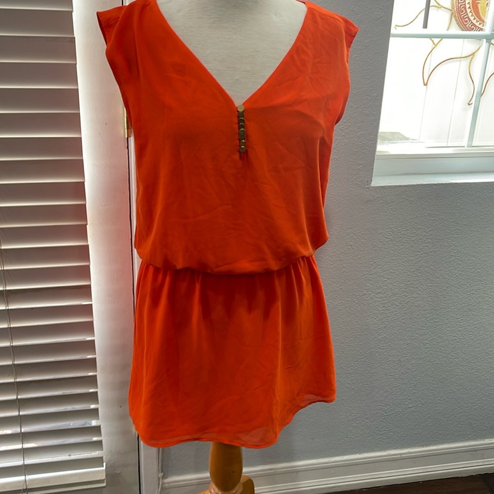 Orange mini dress with gold accent buttons
